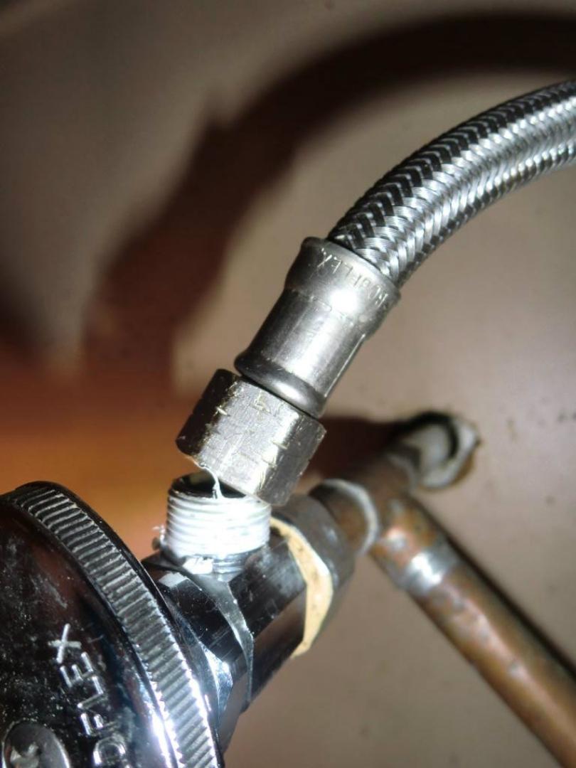 Detach flexible hose from water supply valve